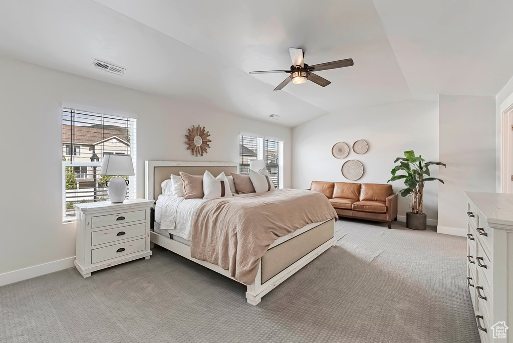 Bedroom with light colored carpet, baseboards, and ceiling fan