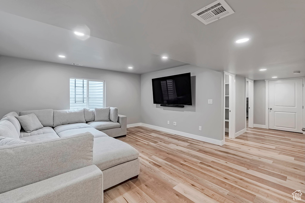 Living area featuring light wood-style floors, recessed lighting, and baseboards