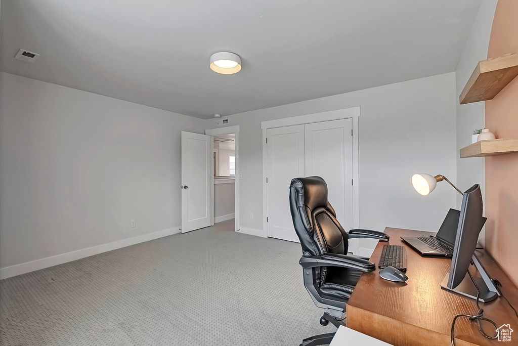 Office area featuring carpet and baseboards
