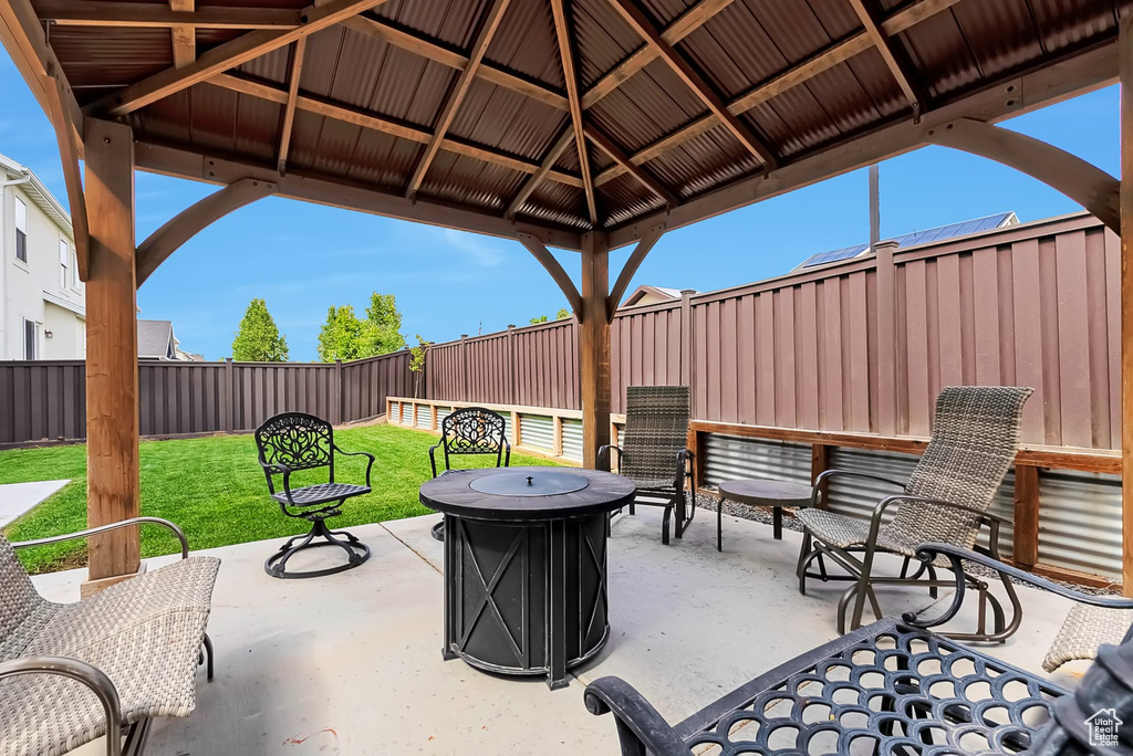 View of patio featuring a gazebo and a fire pit