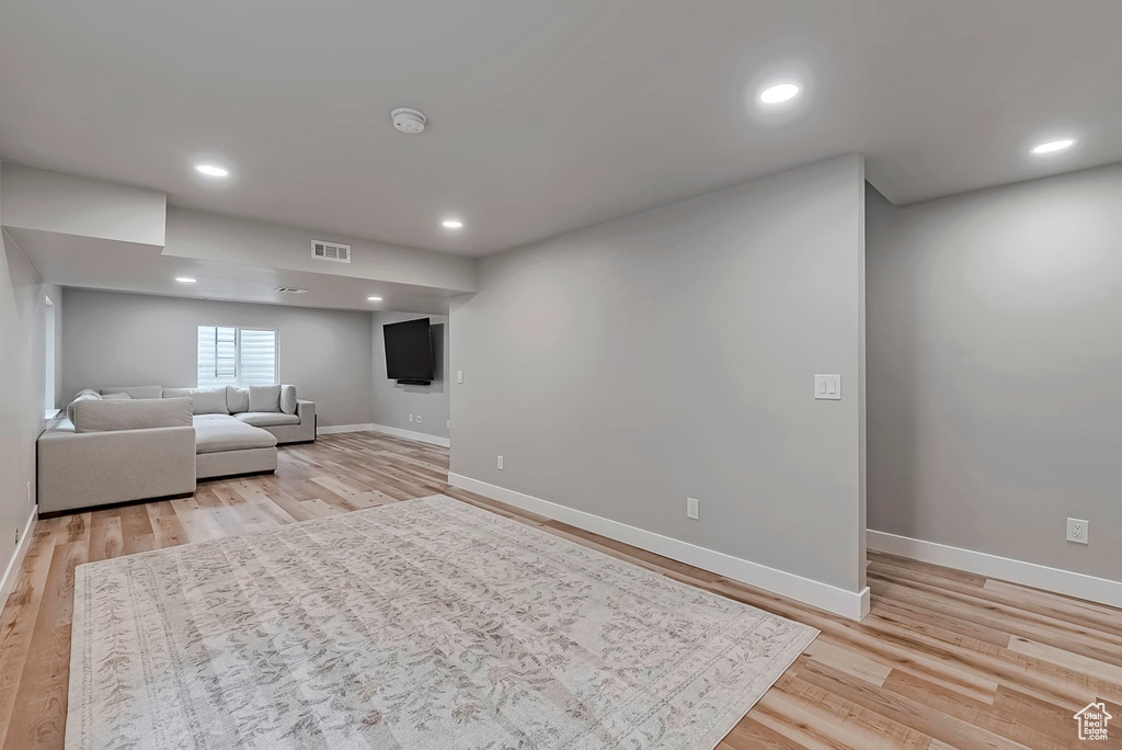 Living room featuring baseboards, light wood-style flooring, and recessed lighting