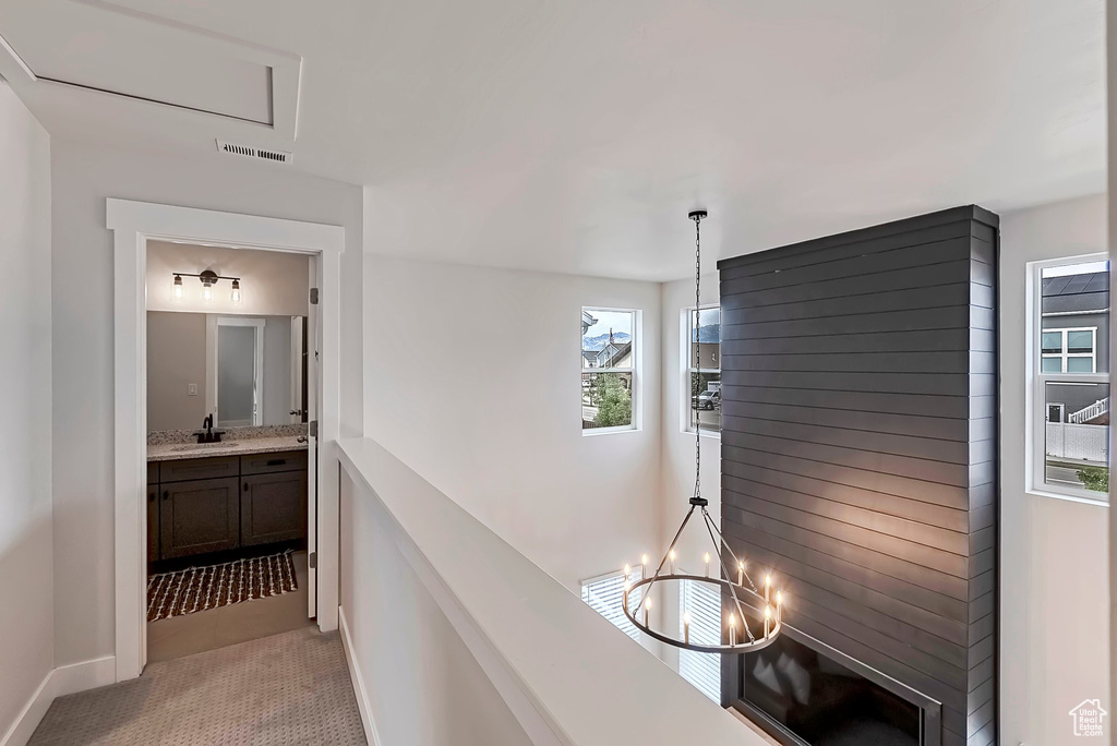 Hall featuring baseboards and light tile patterned floors