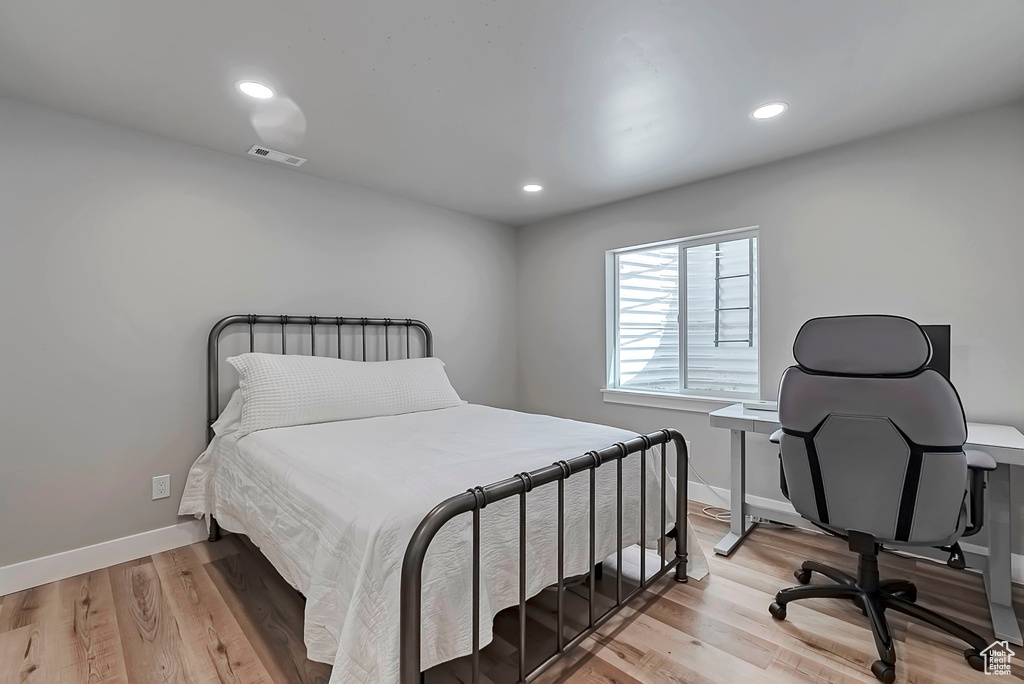 Bedroom featuring light wood-type flooring, baseboards, and recessed lighting
