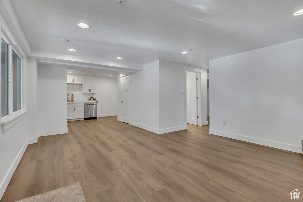 Unfurnished living room featuring recessed lighting, baseboards, and light wood finished floors