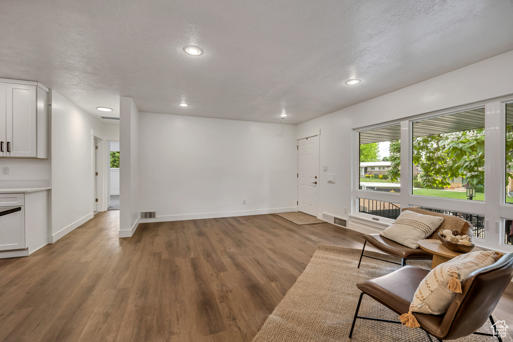 Living area featuring wood finished floors, baseboards, and recessed lighting
