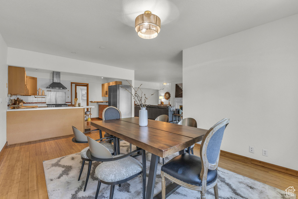 Dining space with light wood-style floors and baseboards