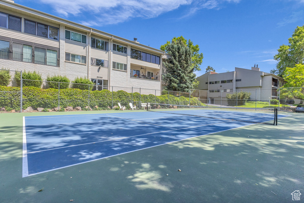 View of tennis court with community basketball court