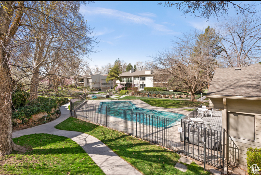 Community pool featuring a patio area and a residential view