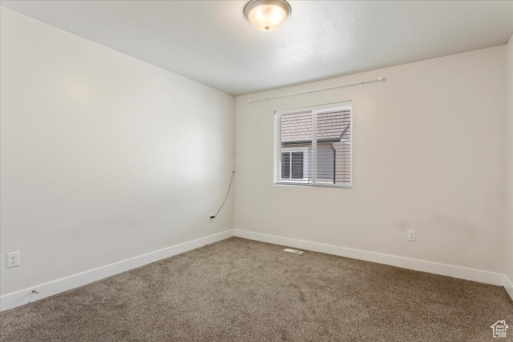 Unfurnished room with carpet floors and baseboards