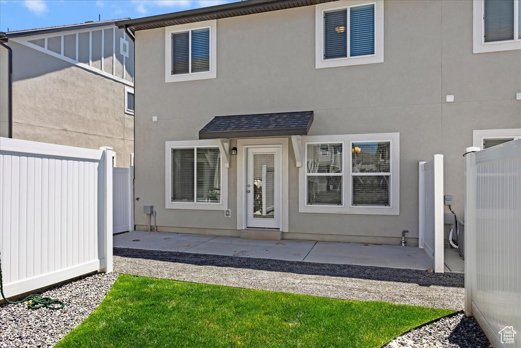 Rear view of property with a patio and stucco siding