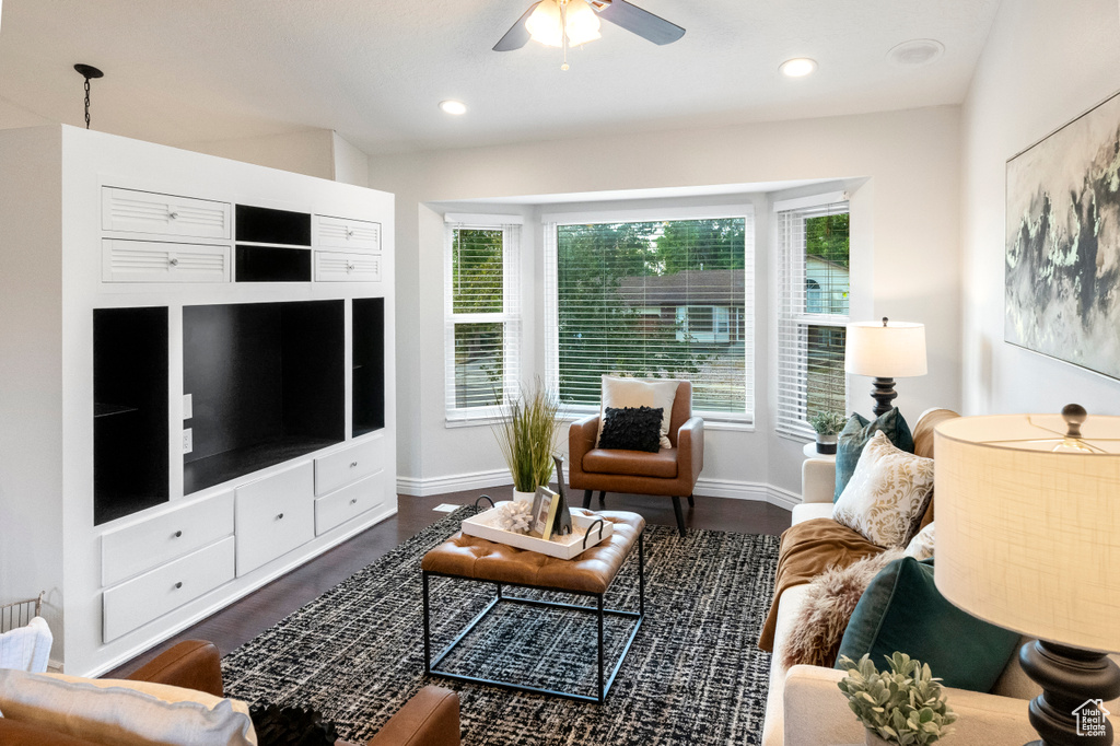 Living room with a ceiling fan, baseboards, dark wood finished floors, and recessed lighting