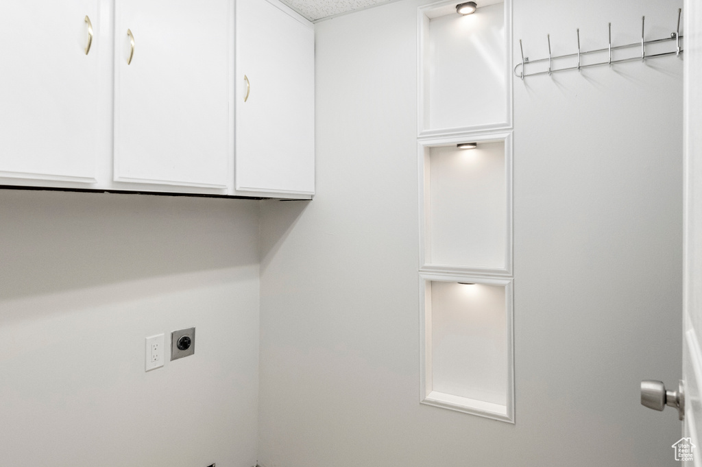 Washroom with hookup for an electric dryer and cabinet space