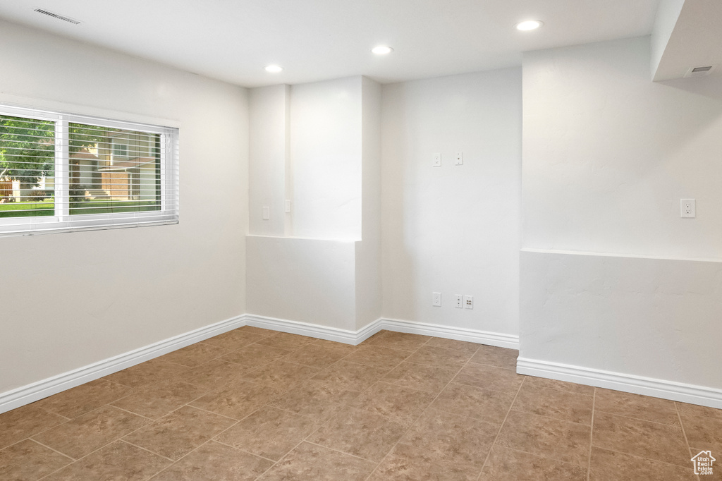 Spare room featuring recessed lighting and baseboards