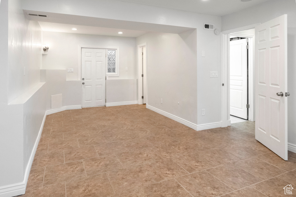 Empty room with recessed lighting and baseboards
