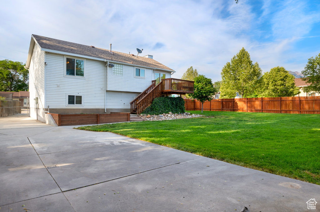 Rear view of property with stairs and a wooden deck