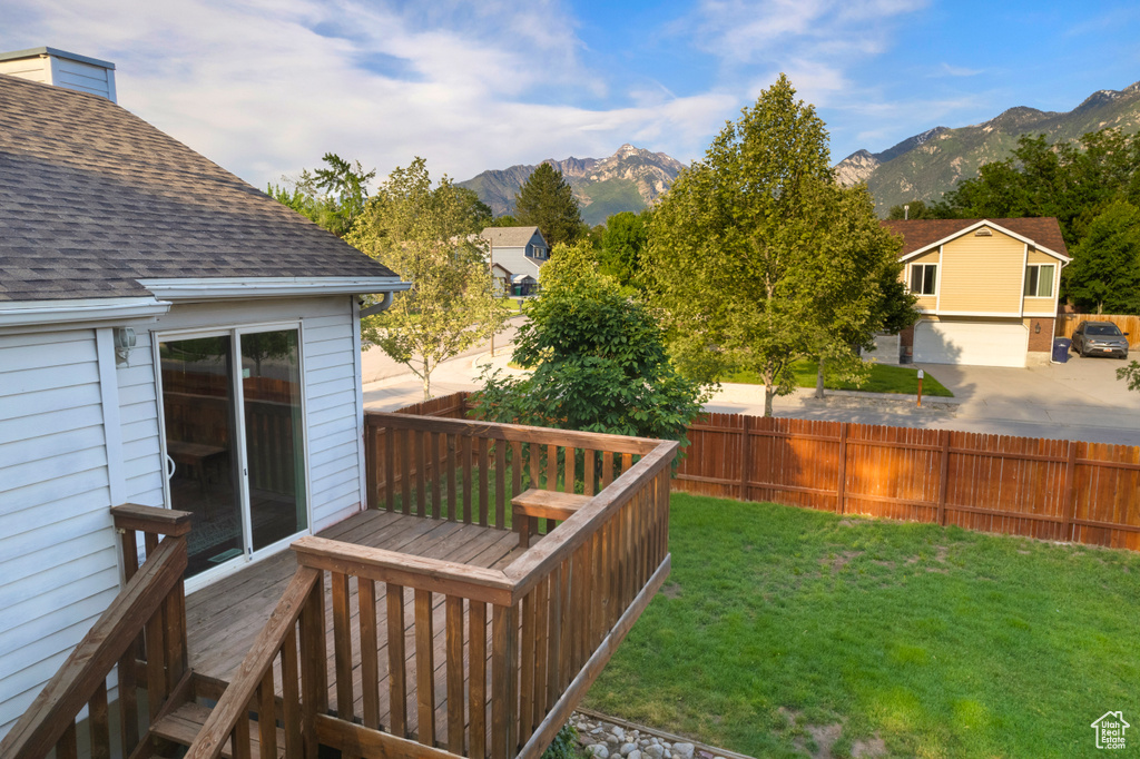 View of yard with a deck with mountain view