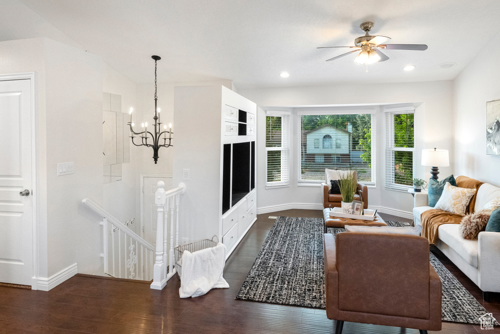 Living area with a chandelier, baseboards, dark wood finished floors, a ceiling fan, and recessed lighting