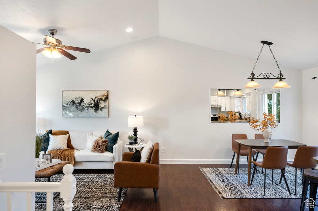 Living area featuring lofted ceiling, a ceiling fan, wood finished floors, baseboards, and recessed lighting