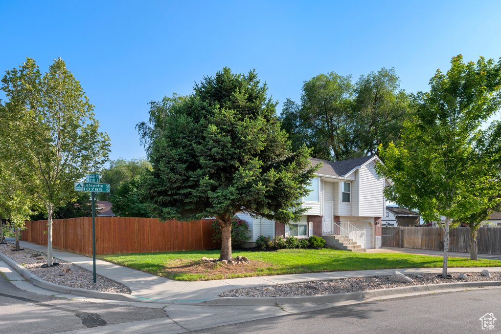 View of front of property featuring an attached garage and driveway