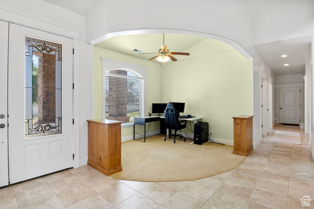 Entryway featuring light tile patterned floors, baseboards, ceiling fan, arched walkways, and recessed lighting