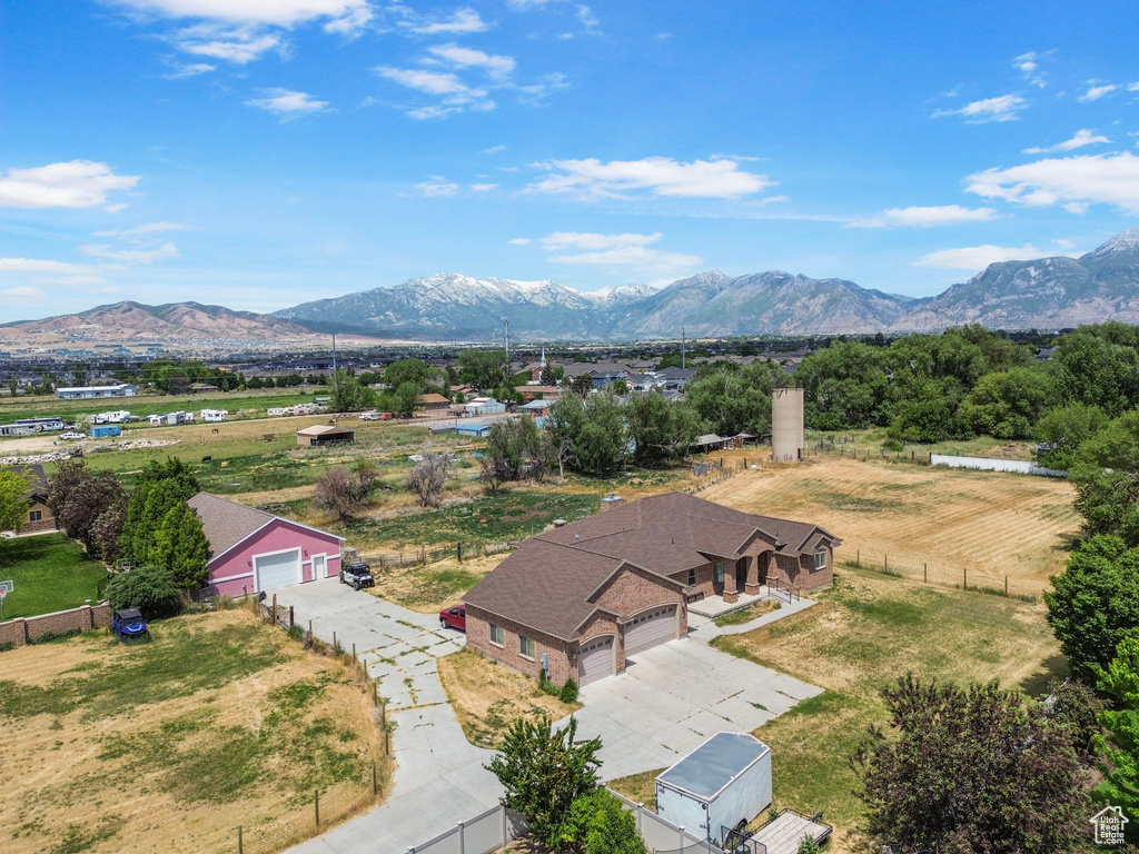 Aerial view of property and surrounding area with a mountainous background