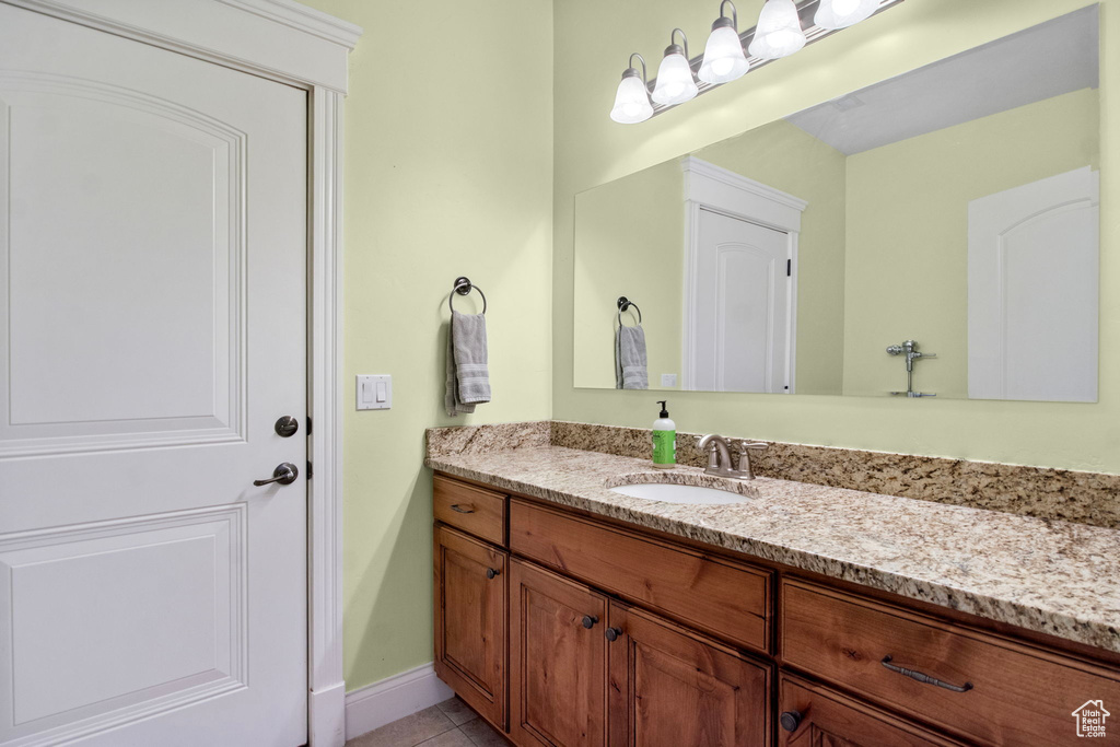 Bathroom with vanity, tile patterned flooring, and baseboards