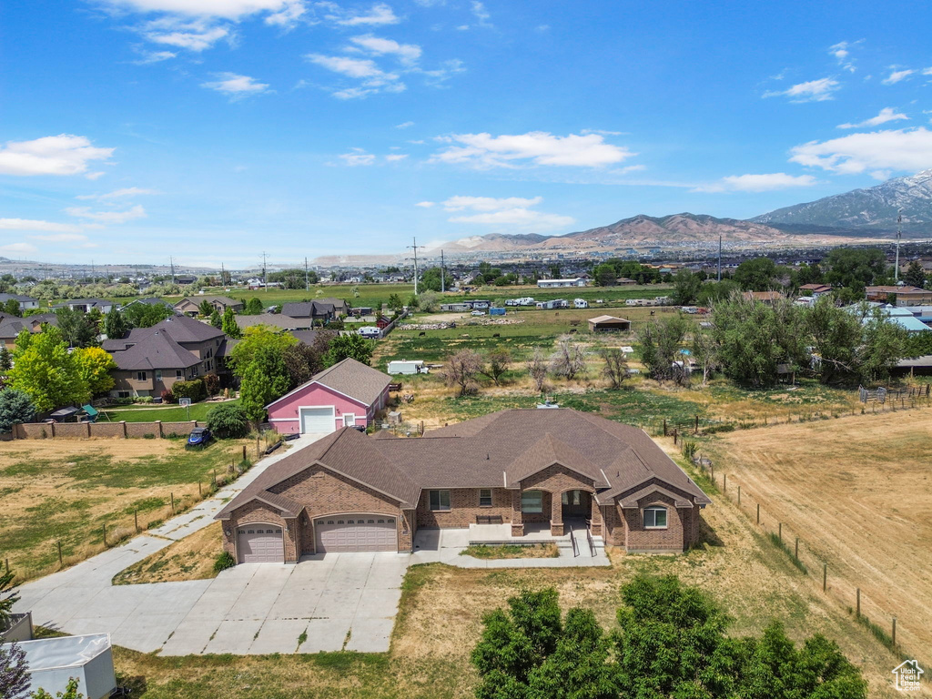Aerial view of property and surrounding area featuring mountains
