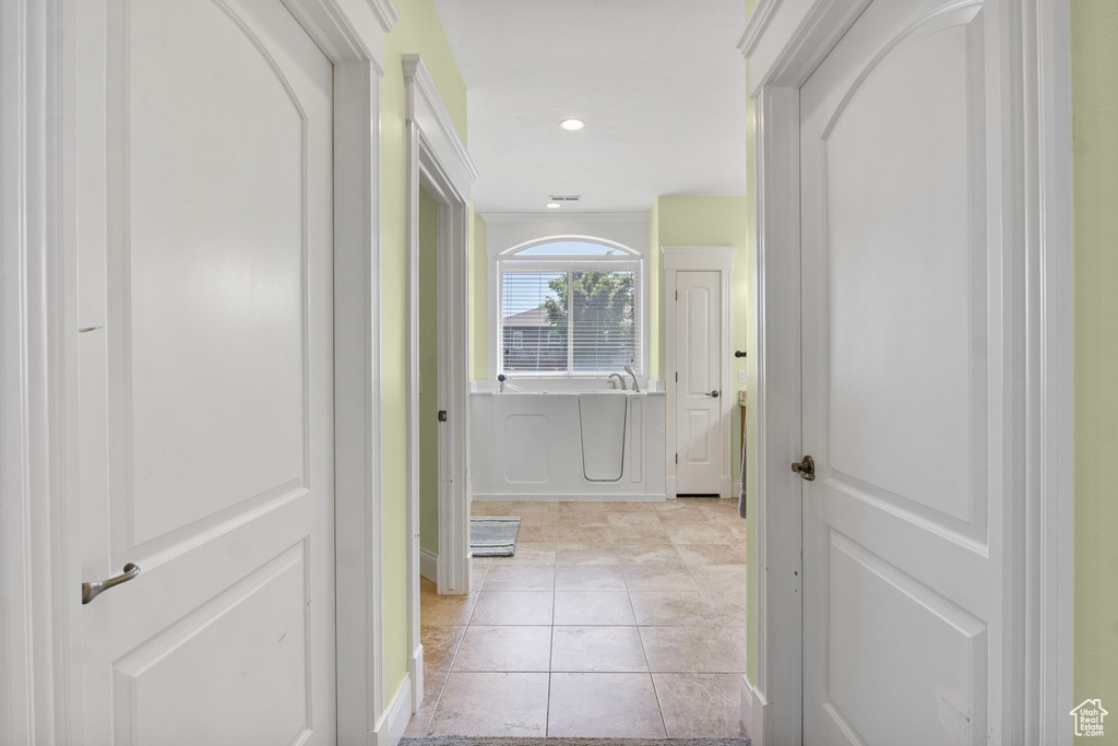 Hallway with light tile patterned floors, recessed lighting, and baseboards