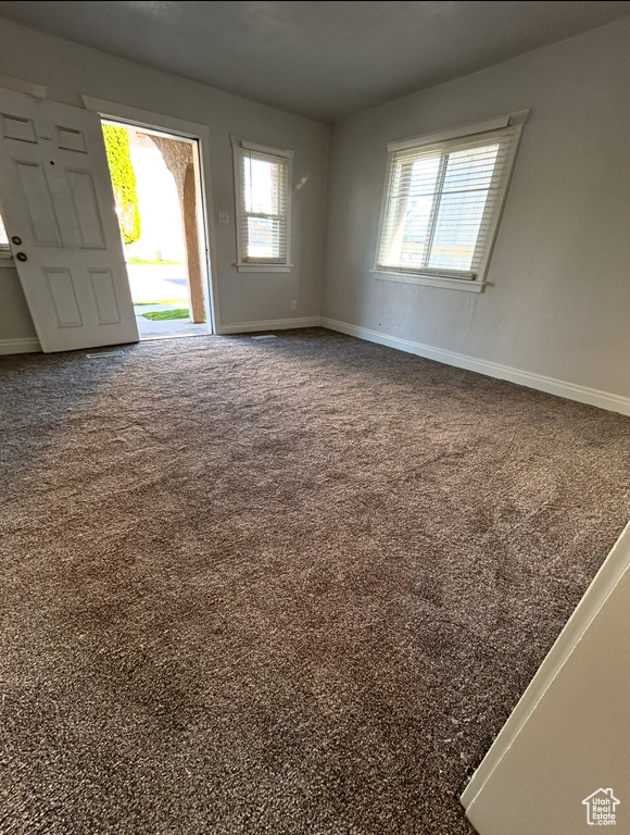 Carpeted empty room with baseboards