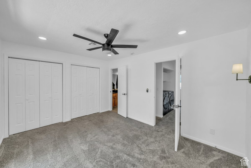 Unfurnished bedroom featuring washer and dryer, carpet floors, recessed lighting, two closets, and baseboards