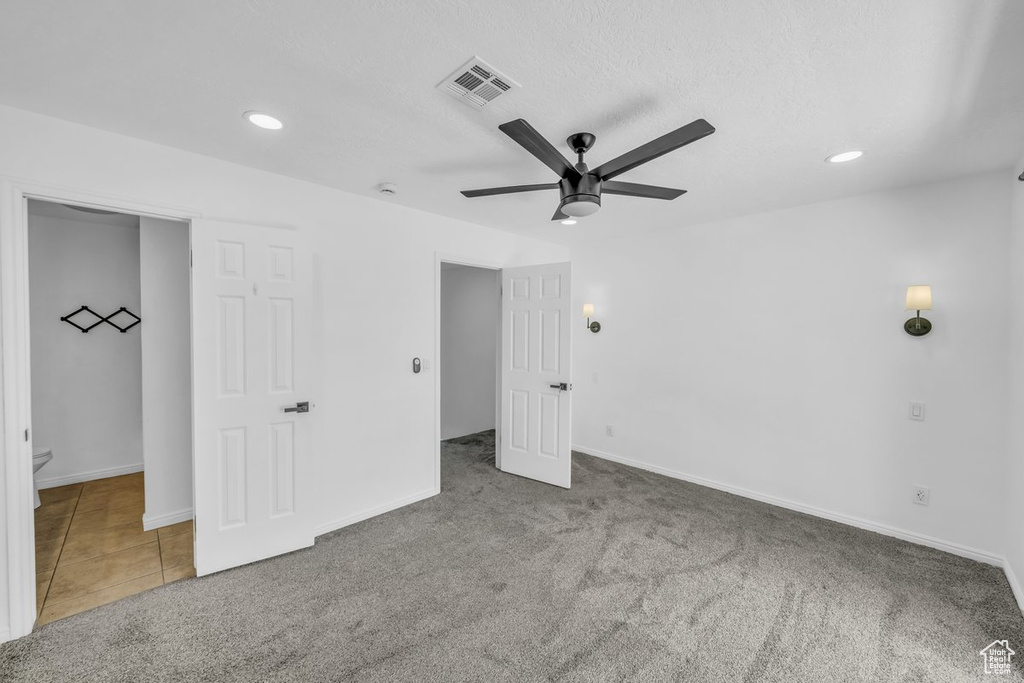 Unfurnished bedroom featuring carpet, recessed lighting, baseboards, and a ceiling fan