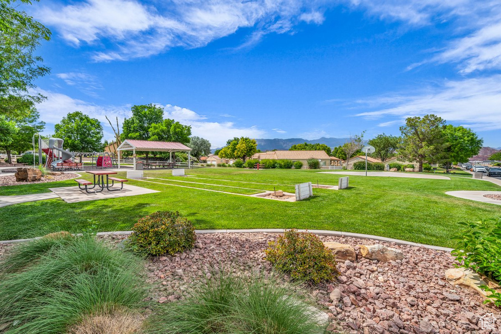 View of property\'s community featuring a gazebo, a lawn, and a mountain view