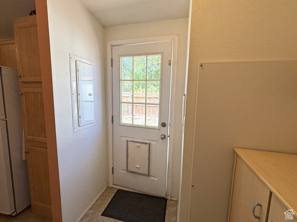 Entryway with electric panel and a textured wall