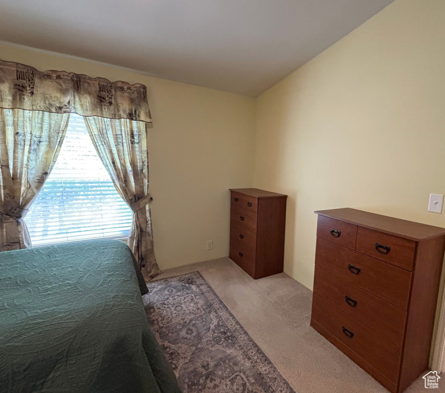 Bedroom with light colored carpet