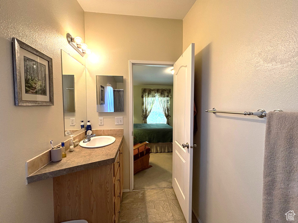 Bathroom with vanity and ensuite bathroom