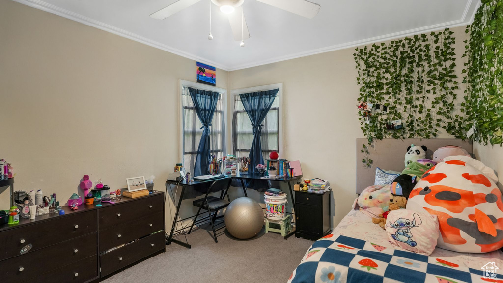 Bedroom with carpet flooring, ornamental molding, and a ceiling fan