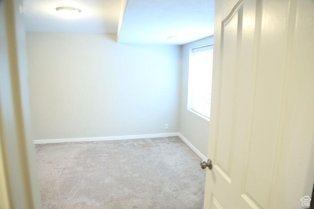 Carpeted spare room with baseboards