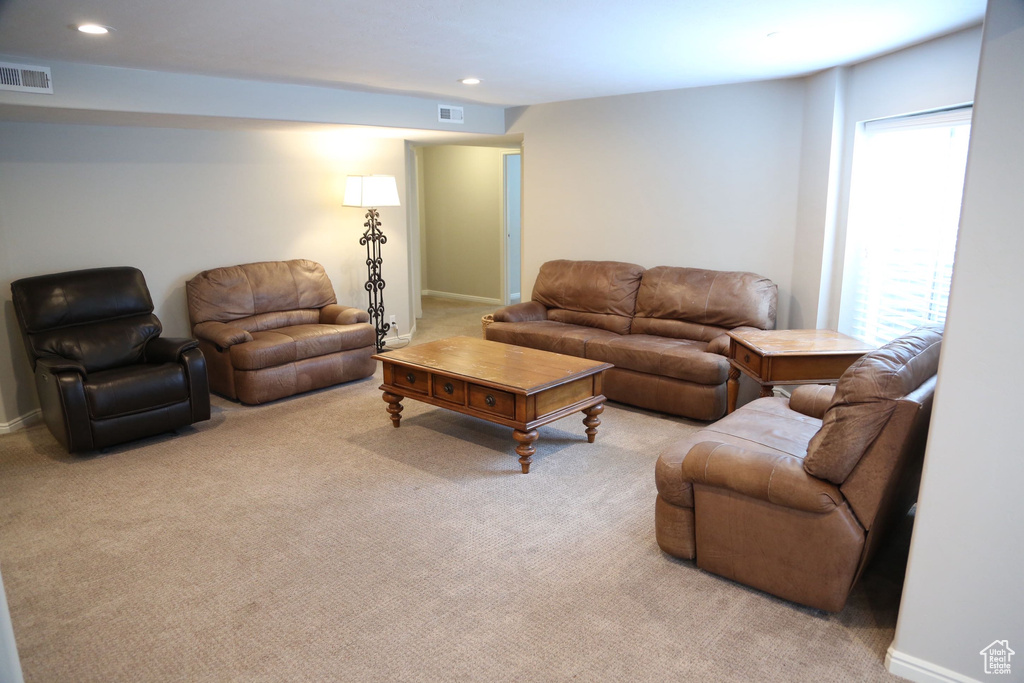 Carpeted living room with recessed lighting and baseboards