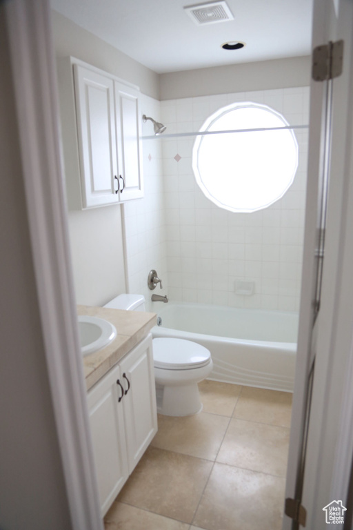 Bathroom with vanity, toilet, washtub / shower combination, and tile patterned flooring