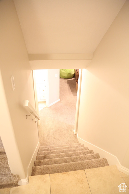 Stairs featuring carpet flooring and baseboards