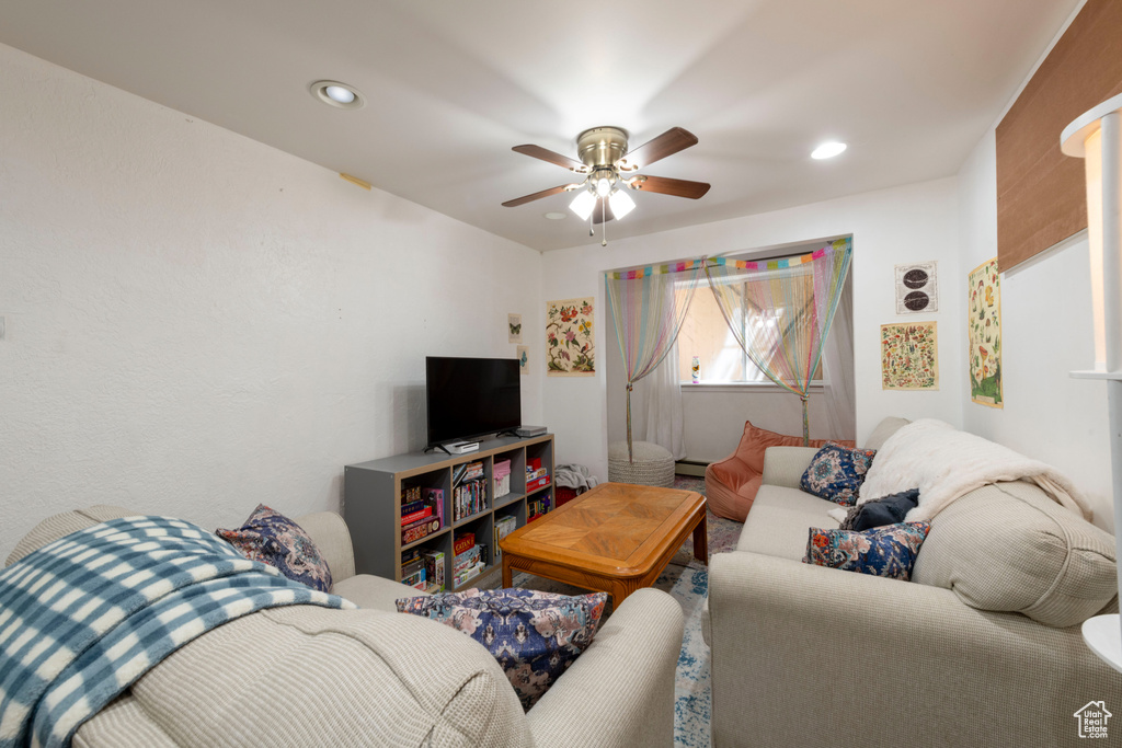 Living room featuring a ceiling fan and recessed lighting