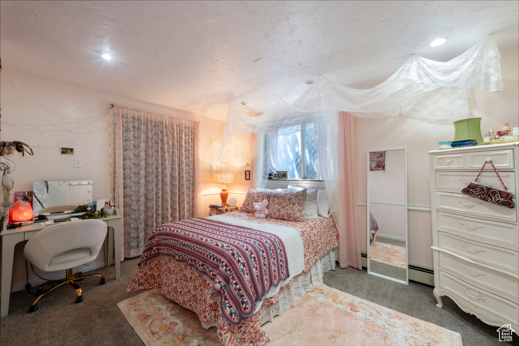 Bedroom with carpet floors, an office area, recessed lighting, and a baseboard radiator