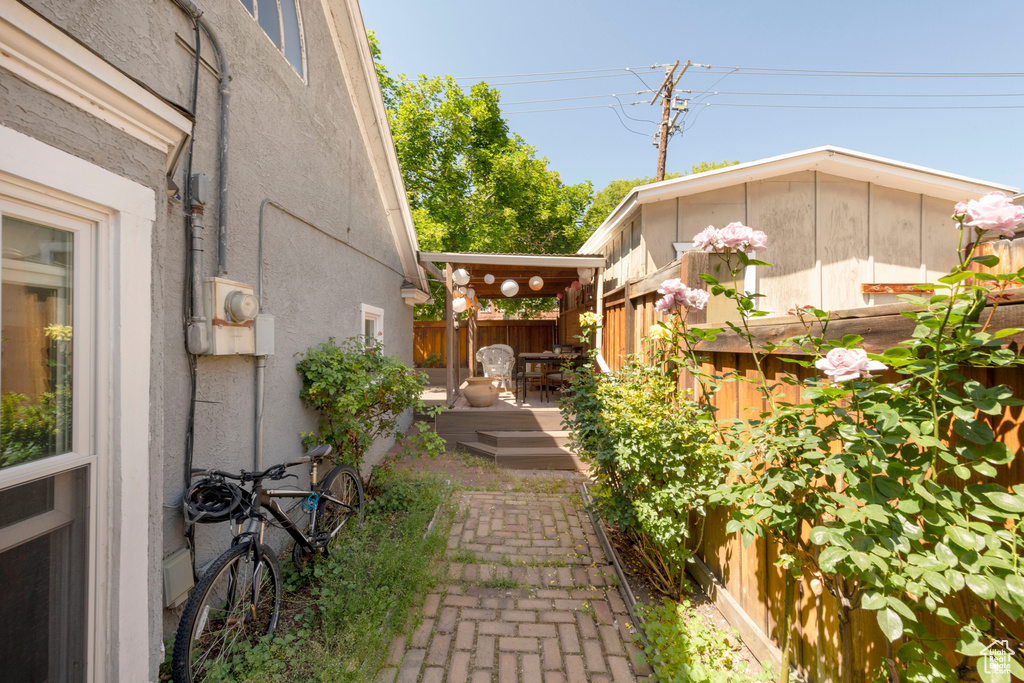 View of property exterior featuring a fenced backyard, a wooden deck, and stucco siding