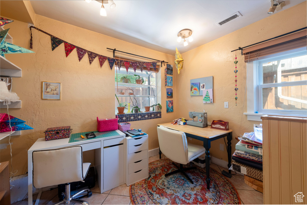 Office with plenty of natural light and light tile patterned floors
