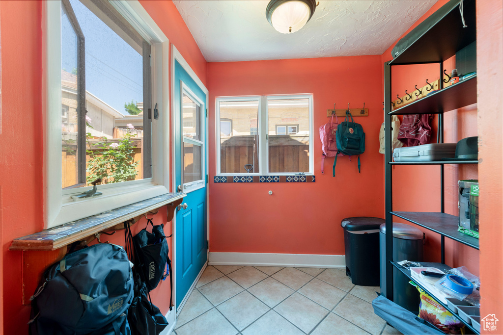 Interior space featuring baseboards and light tile patterned floors