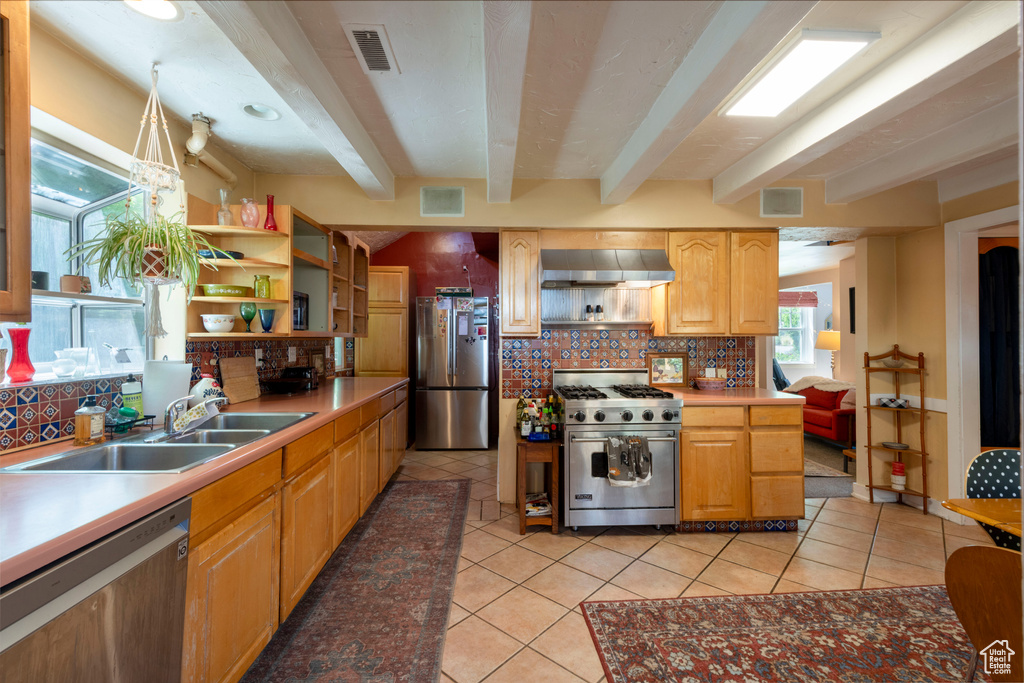 Kitchen featuring appliances with stainless steel finishes, open shelves, exhaust hood, beamed ceiling, and decorative backsplash
