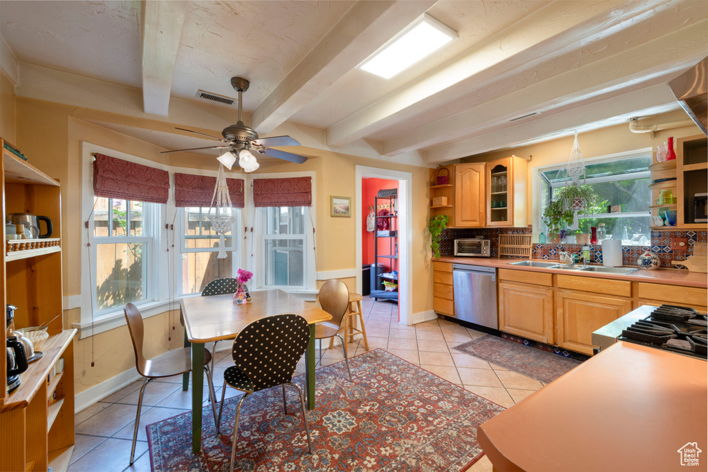 Kitchen with dishwasher, open shelves, light tile patterned floors, baseboards, and beam ceiling