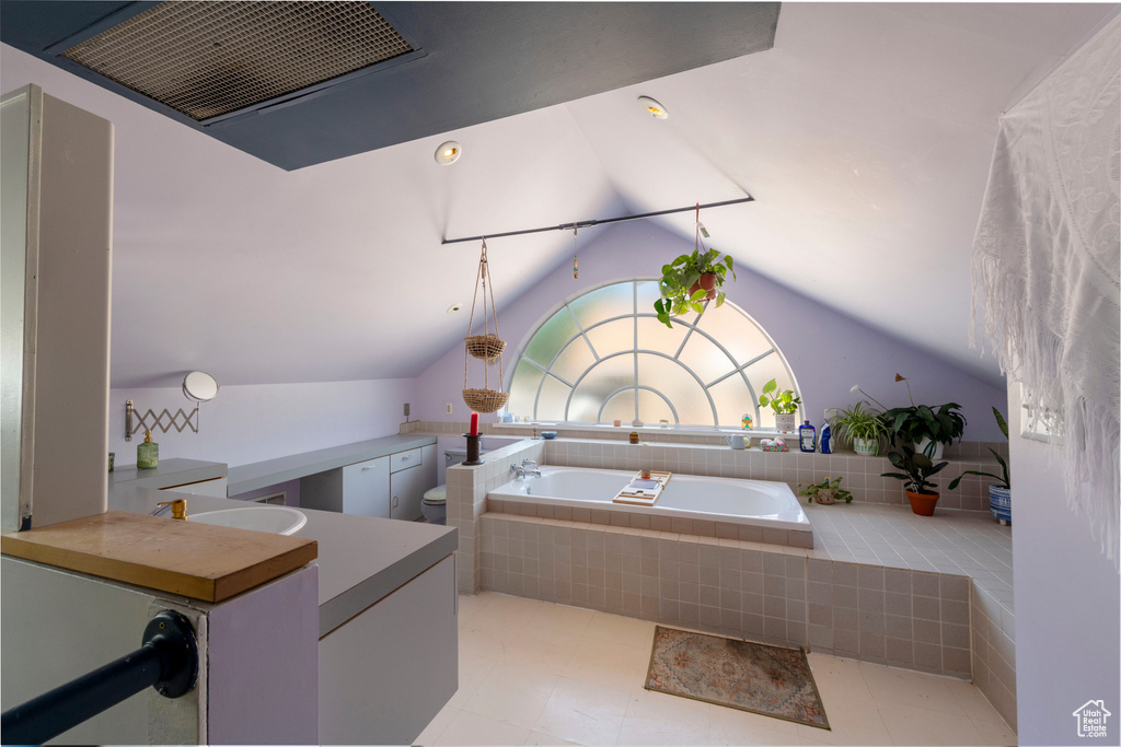 Kitchen with vaulted ceiling and ventilation hood