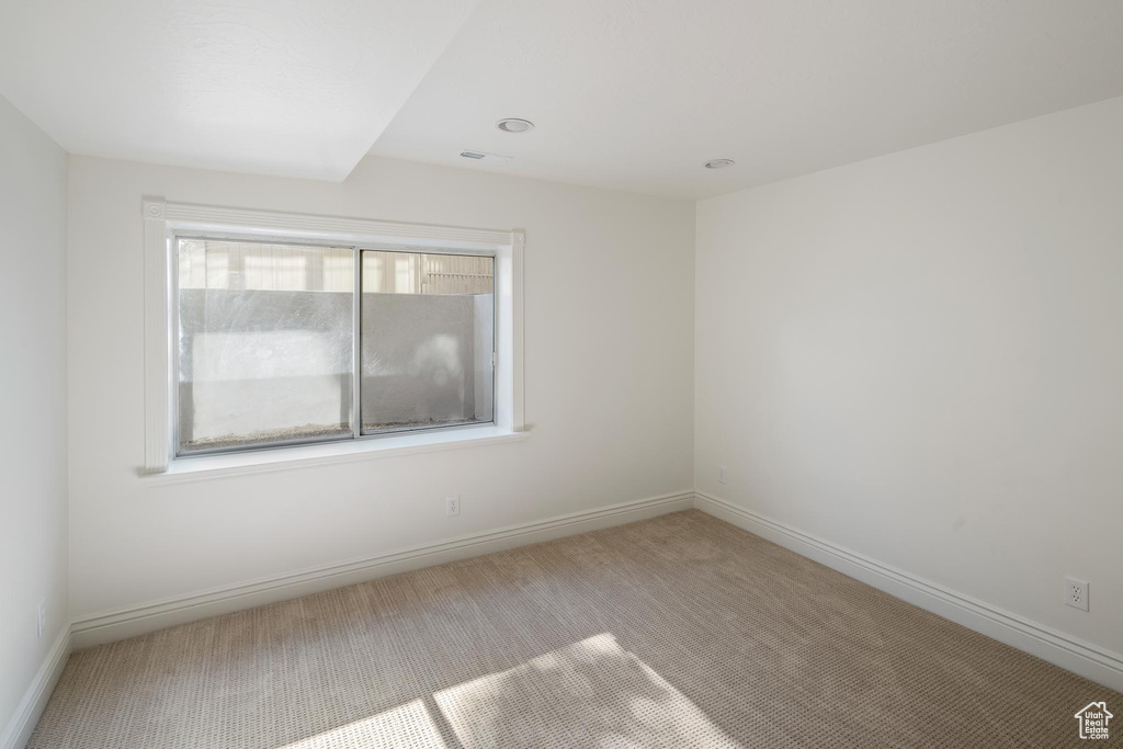 Unfurnished room featuring carpet and baseboards