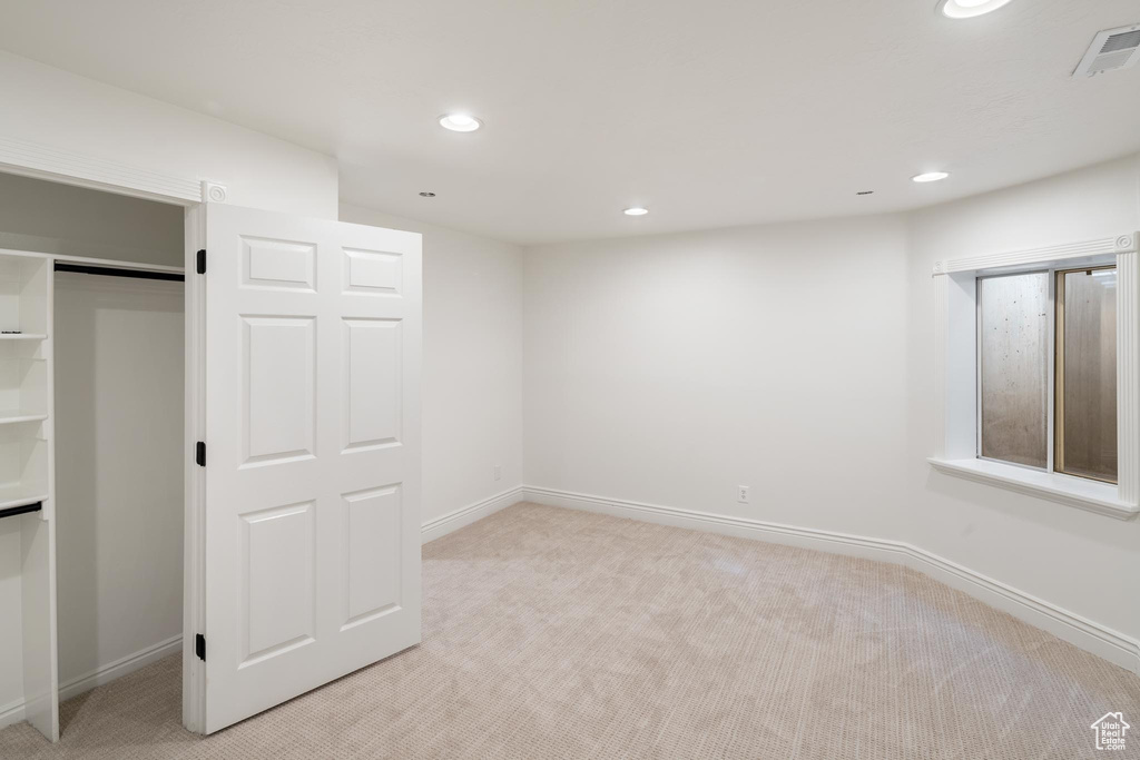 Unfurnished bedroom with light carpet, recessed lighting, baseboards, and a closet